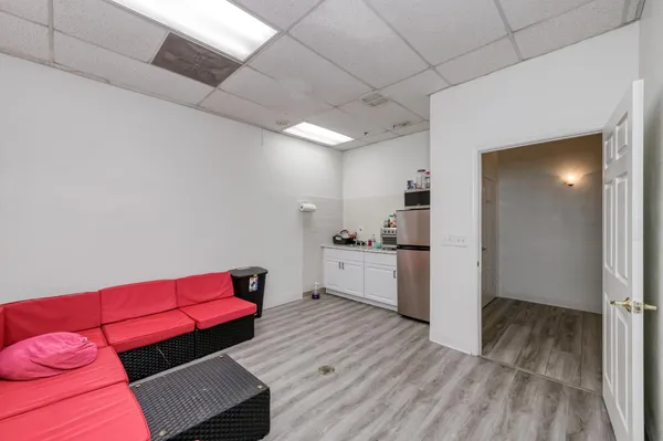 a kitchen with a refrigerator sink and cabinets