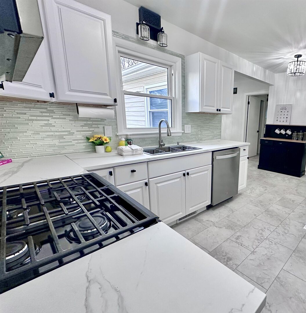 1830 28th Street Rock Island, IL 61201 - Photo 8 of 23 a kitchen with a sink a stove and cabinets