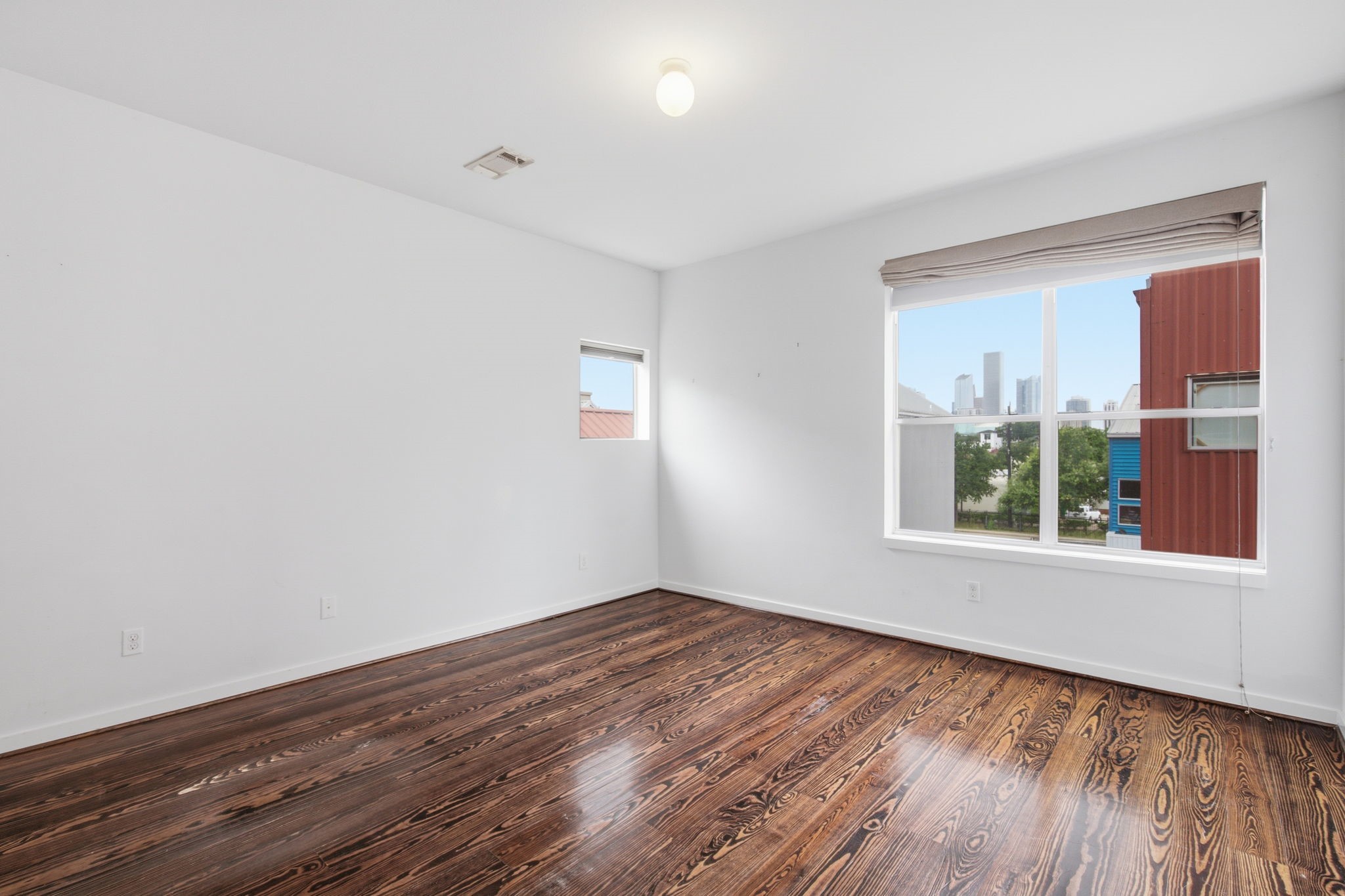 2934 Commerce Street Houston, TX 77003 - Photo 19 of 44 a view of an empty room with wooden floor and a window