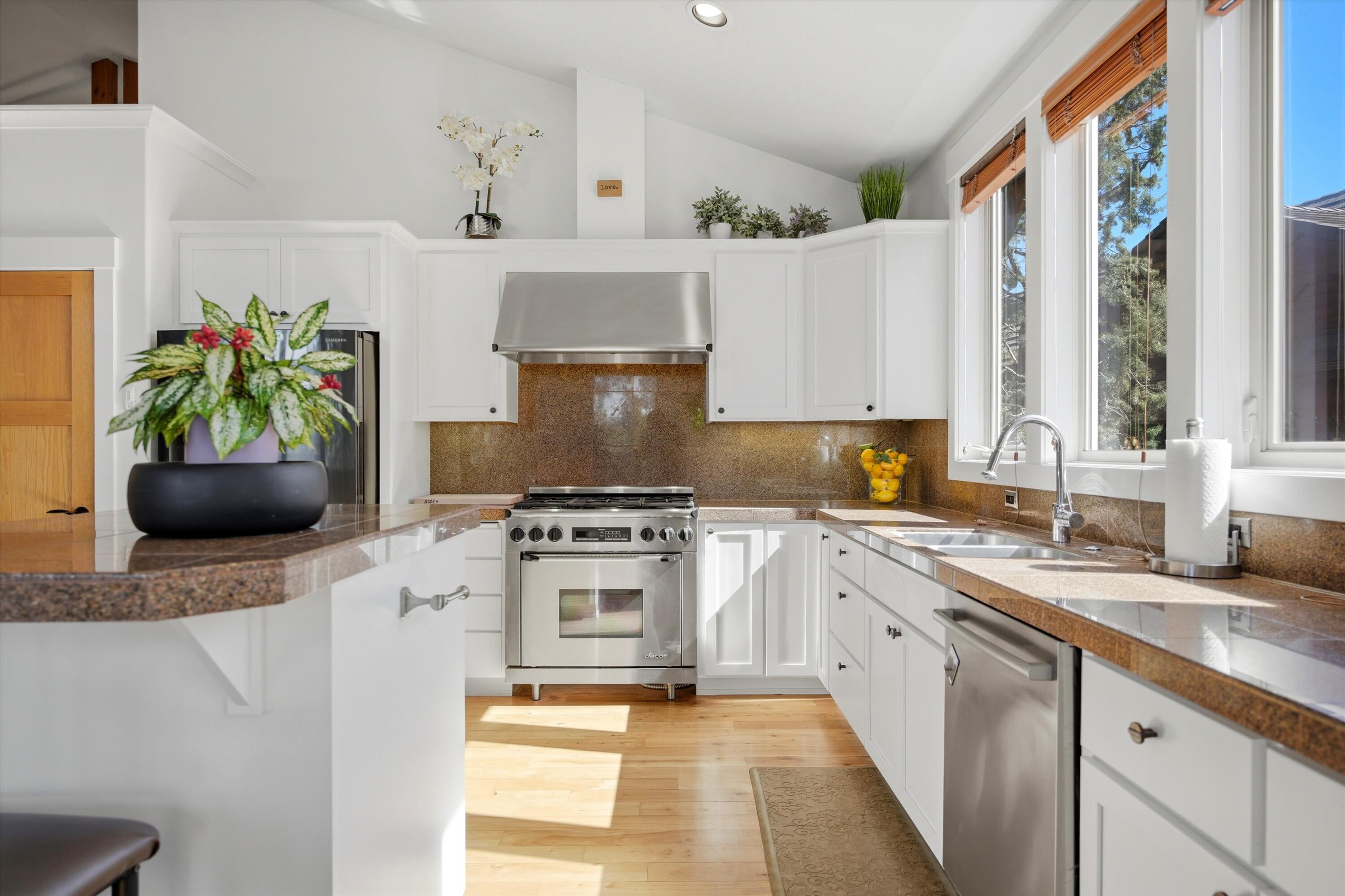 15 Southwest Quail Butte Place Bend, OR 97703 - Photo 13 of 55 a kitchen with stainless steel appliances granite countertop a sink a stove and a refrigerator