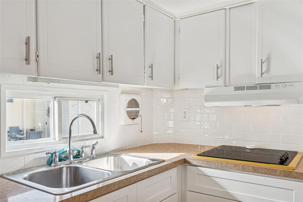 86 Pindo Palm Street West Largo, FL 33770 - Photo 11 of 45 a kitchen with a sink and cabinets