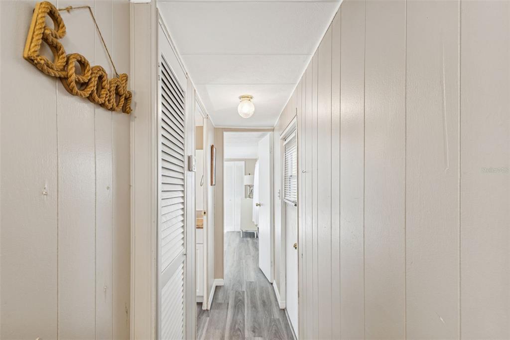 86 Pindo Palm Street West Largo, FL 33770 - Photo 12 of 45 a view of a hallway with wooden floor and entryway