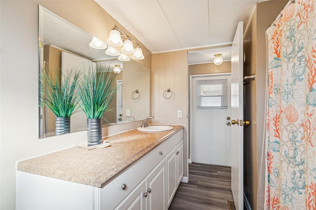 86 Pindo Palm Street West Largo, FL 33770 - Photo 15 of 45 a bathroom with a granite countertop sink and a mirror