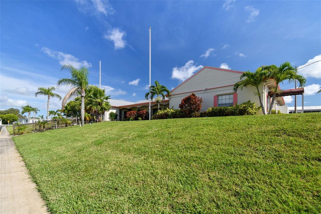 86 Pindo Palm Street West Largo, FL 33770 - Photo 36 of 45 a view of a house with a big yard and potted plants