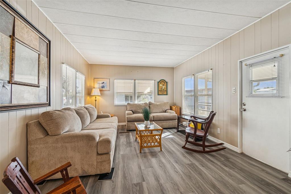 86 Pindo Palm Street West Largo, FL 33770 - Photo 7 of 45 a living room with furniture a wooden floor and a large window