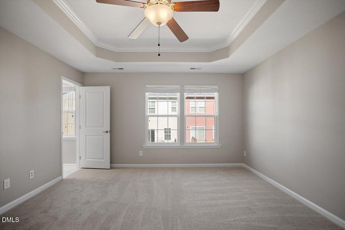 117 Brier Ridge Drive Durham, NC 27703 - Photo 19 of 29 an empty room with windows and chandelier fan