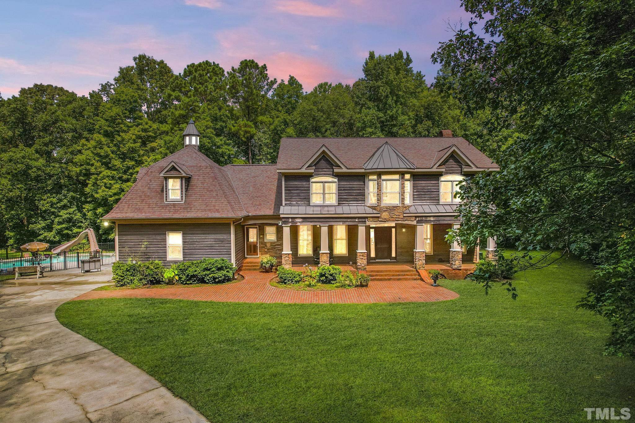 a front view of a house with a yard table and chairs
