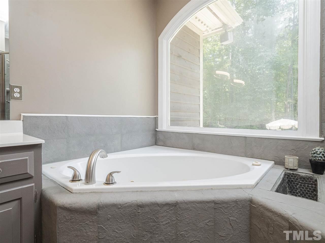 552 Tom Wright Road, Unit LO4 Franklinton, NC 27525 - Photo 16 of 30 a bathroom with bathtub and window