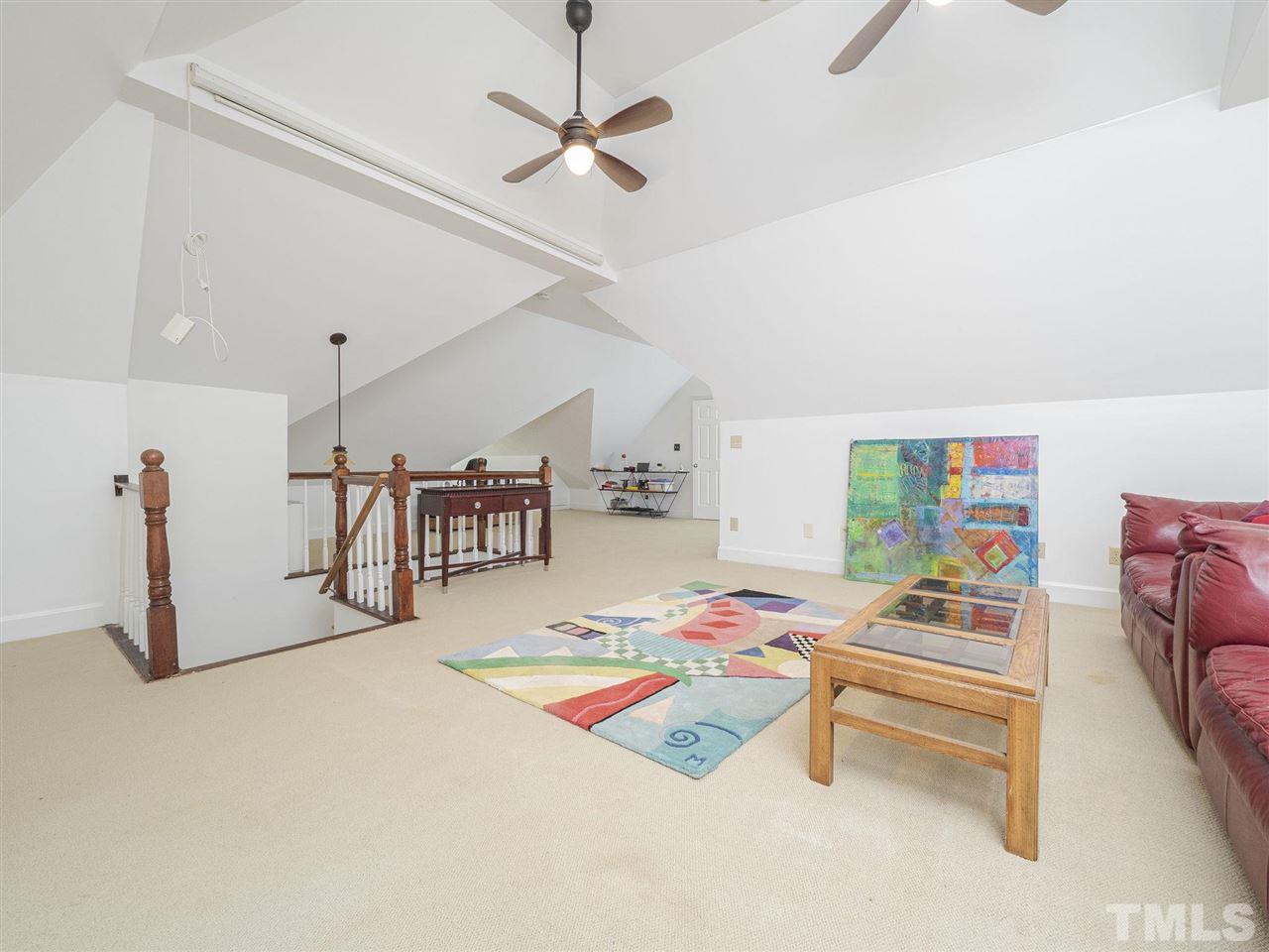 552 Tom Wright Road, Unit LO4 Franklinton, NC 27525 - Photo 24 of 30 a bedroom with furniture and a chandelier