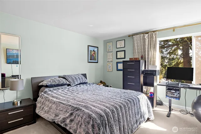 a bedroom with a bed and a couch