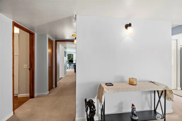 a view of hallway with furniture and window