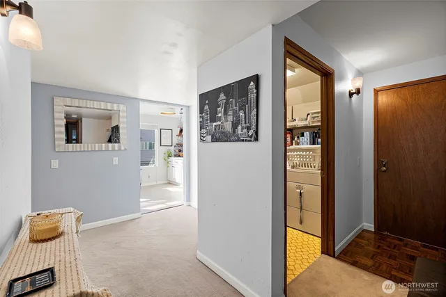 a view of a hallway with closet and wooden floor