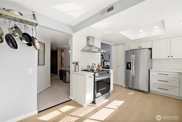 a kitchen with a refrigerator and a stove