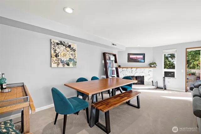 a living room with furniture a piano and a bookshelf
