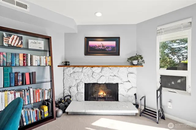 a living room with fireplace furniture and a window