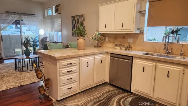 a kitchen with cabinets appliances a sink and a counter top space