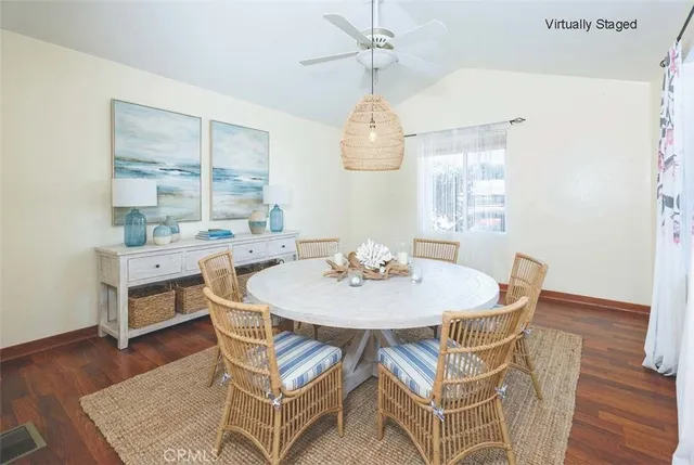 a view of a dining room with furniture wooden floor and chandelier