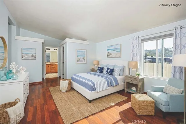 a spacious bedroom with a bed couch and a large window