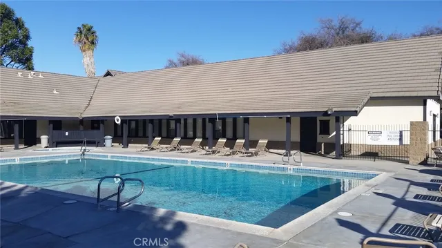 a view of a house with swimming pool and sitting area