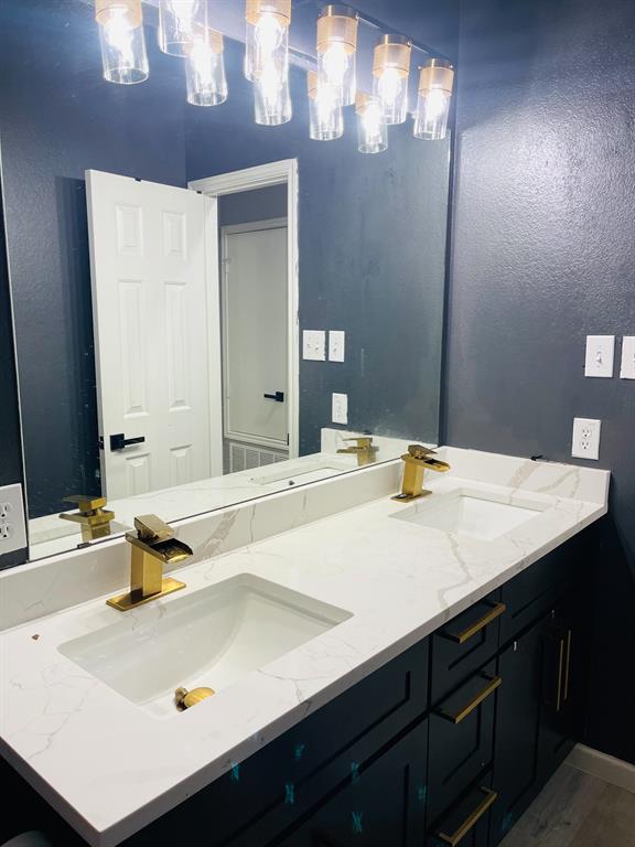 516 Angela Lane Euless, TX 76039 - Photo 27 of 39 Bathroom featuring a textured wall and dark wood-style floors