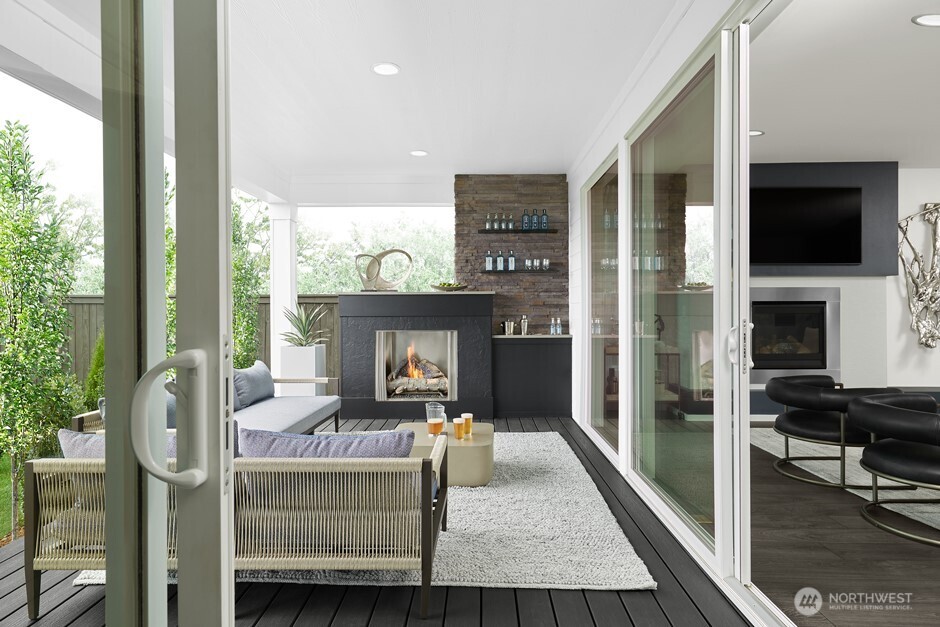 32113 Victoria Street Carnation, WA 98014 - Photo 8 of 11 a living room with furniture a flat screen tv and a fireplace