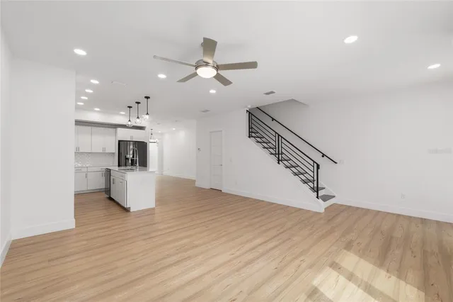 a kitchen with stainless steel appliances a refrigerator sink and wooden cabinets