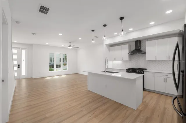 a kitchen with a stove and a white cabinets