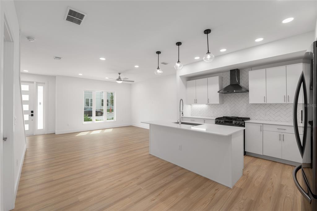 3288 Southwest 49th Terrace Gainesville, FL 32608 - Photo 14 of 71 a kitchen with stainless steel appliances granite countertop a sink a stove a refrigerator and a microwave