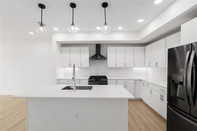 a kitchen with sink and refrigerator