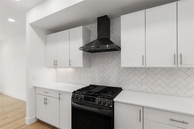a kitchen with a sink stove and cabinets
