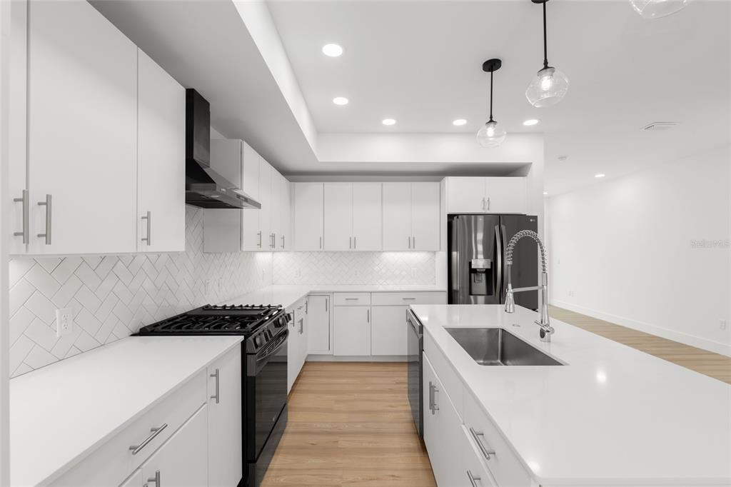 3288 Southwest 49th Terrace Gainesville, FL 32608 - Photo 19 of 71 a kitchen with a sink stove and cabinets