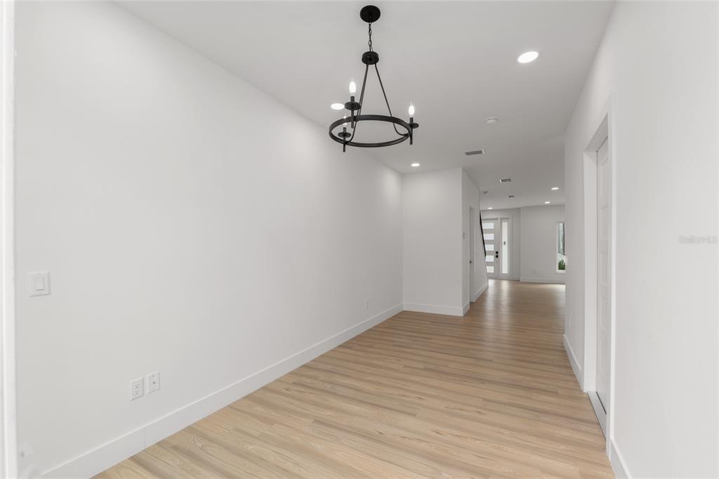 3288 Southwest 49th Terrace Gainesville, FL 32608 - Photo 21 of 71 a view of a room with wooden floor and ceiling fan