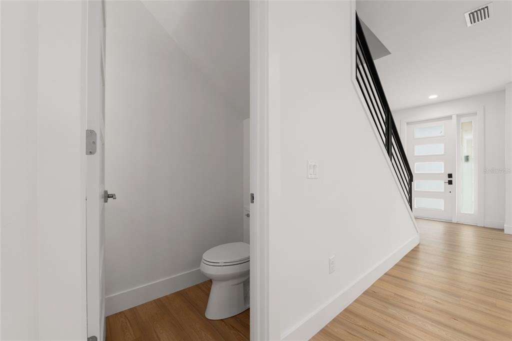 3288 Southwest 49th Terrace Gainesville, FL 32608 - Photo 27 of 71 a view of a hallway with wooden floor and staircase