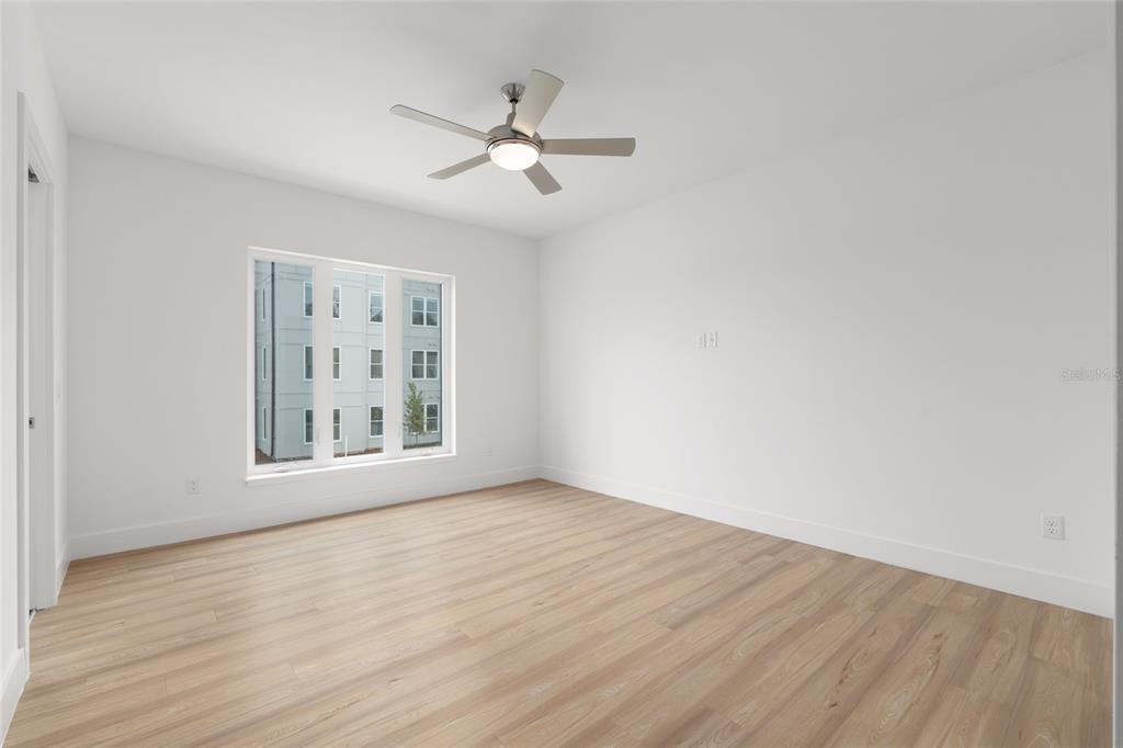 3288 Southwest 49th Terrace Gainesville, FL 32608 - Photo 33 of 71 a view of an empty room with wooden floor and a window