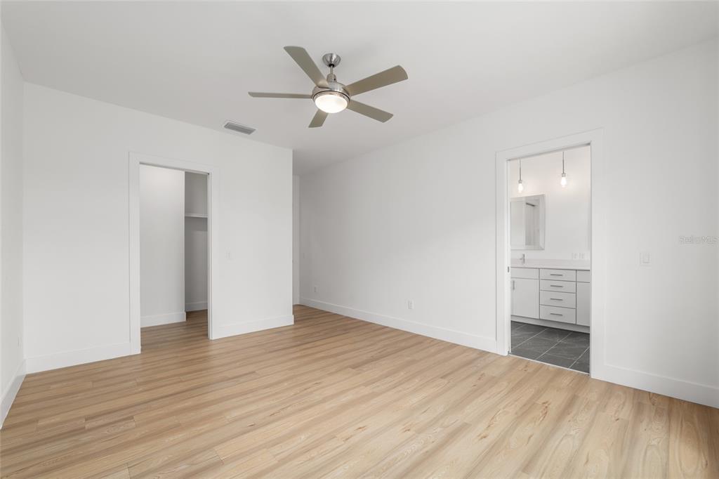 3288 Southwest 49th Terrace Gainesville, FL 32608 - Photo 34 of 71 an empty room with wooden floor fan and windows