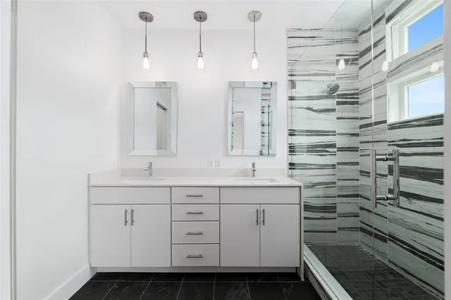an empty room with wooden floor ceiling fan and windows