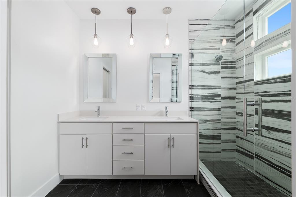 3288 Southwest 49th Terrace Gainesville, FL 32608 - Photo 36 of 71 a bathroom with a double vanity sink a toilet and a mirror