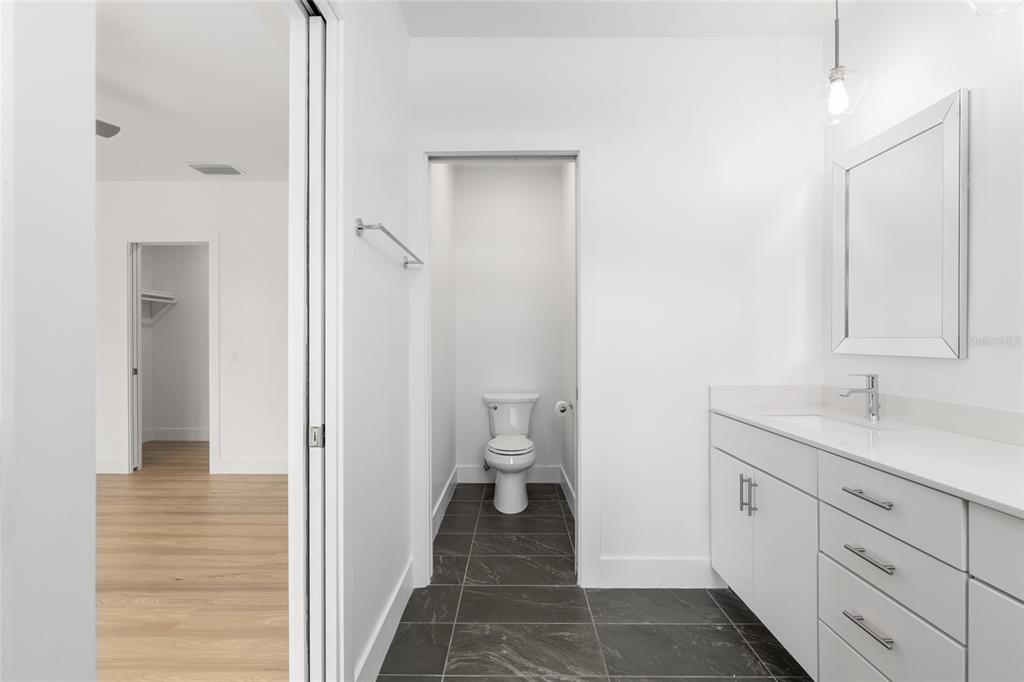 3288 Southwest 49th Terrace Gainesville, FL 32608 - Photo 40 of 71 a bathroom with a granite countertop sink toilet and shower