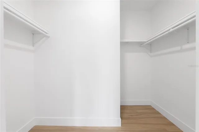 a front view of a house with a yard and potted plants
