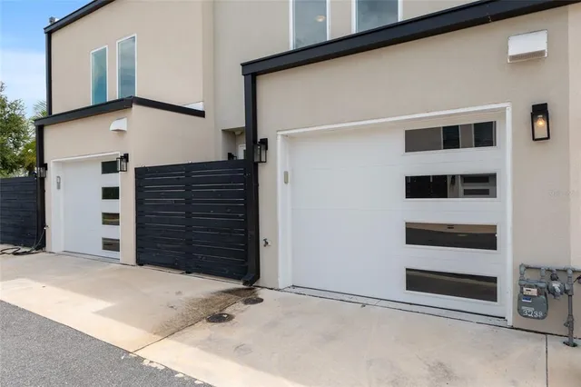 an aerial view of residential houses with outdoor space and street view