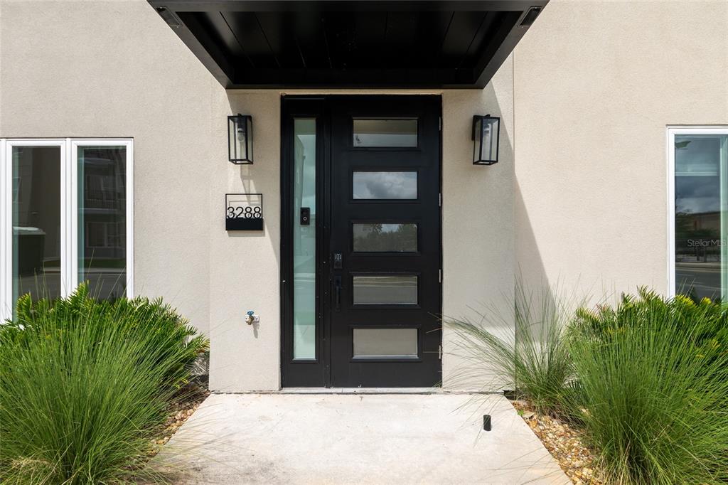 3288 Southwest 49th Terrace Gainesville, FL 32608 - Photo 5 of 71 a view of potted plant in front of a door