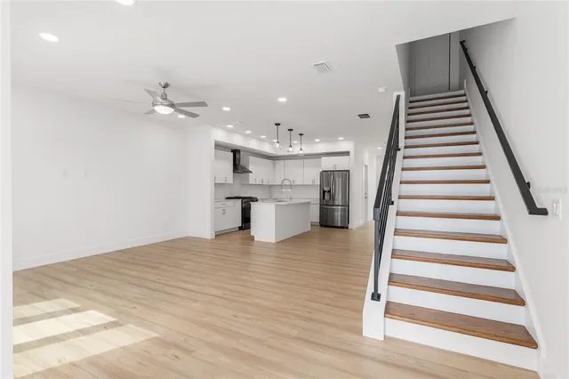 a view of kitchen with cabinets appliances and wooden floor