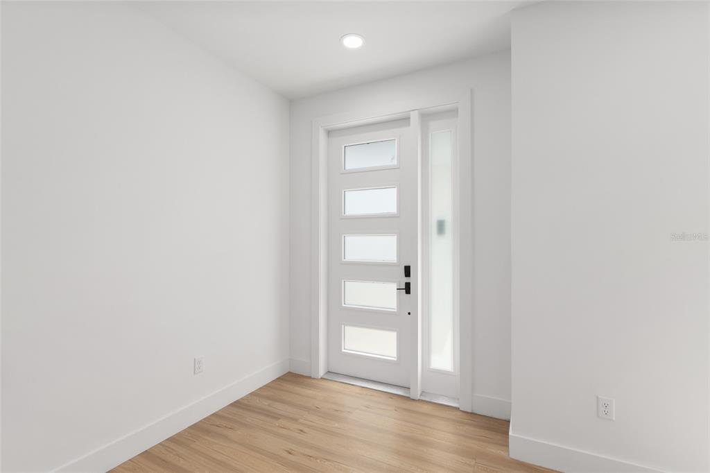 3288 Southwest 49th Terrace Gainesville, FL 32608 - Photo 7 of 71 a view of an empty room with wooden floor