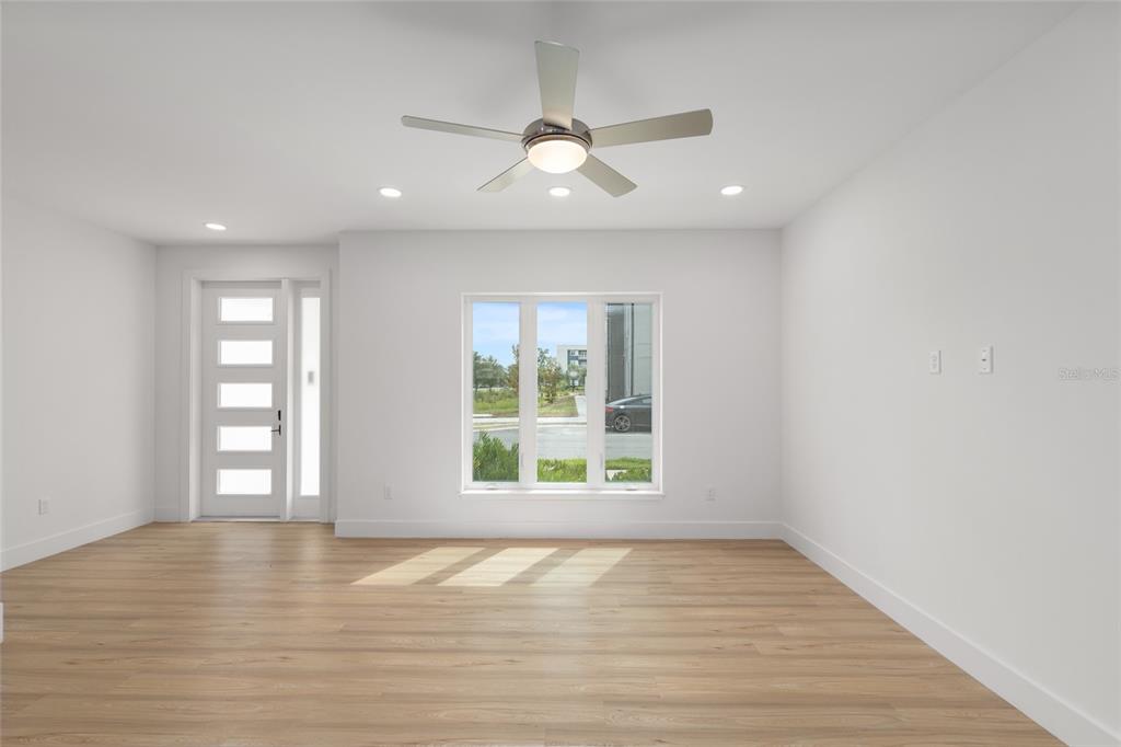 3288 Southwest 49th Terrace Gainesville, FL 32608 - Photo 9 of 71 a view of an empty room with window and wooden floor