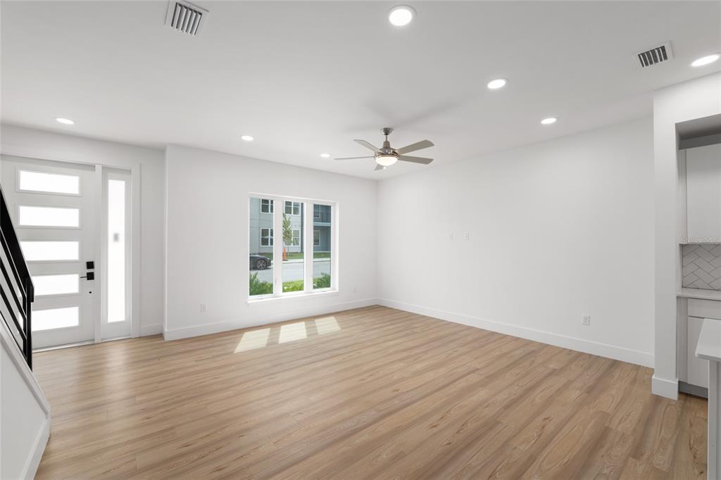 3288 Southwest 49th Terrace Gainesville, FL 32608 - Photo 10 of 71 a view of an empty room with wooden floor and a window