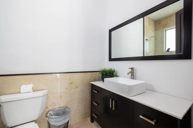 a aerial view of a house with a garden and lake view