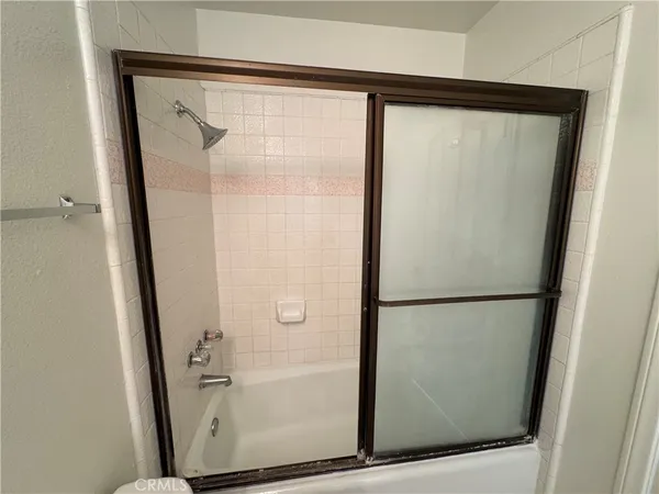 a bathroom with a glass shower door