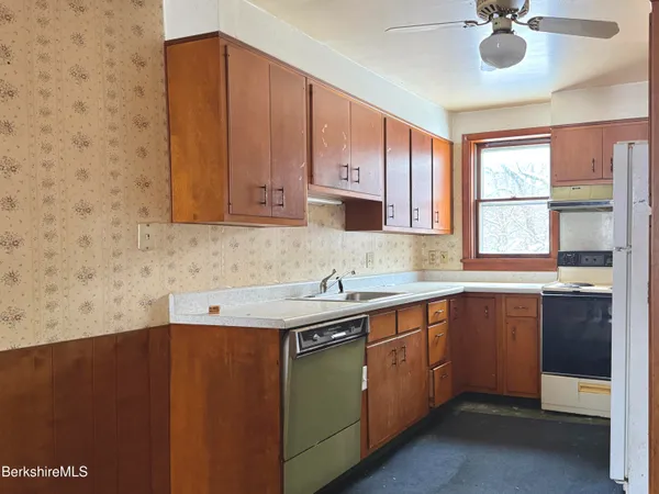 a bathroom with a tub sink and window