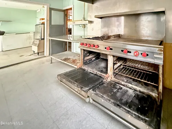 a view of a hallway with wooden walls