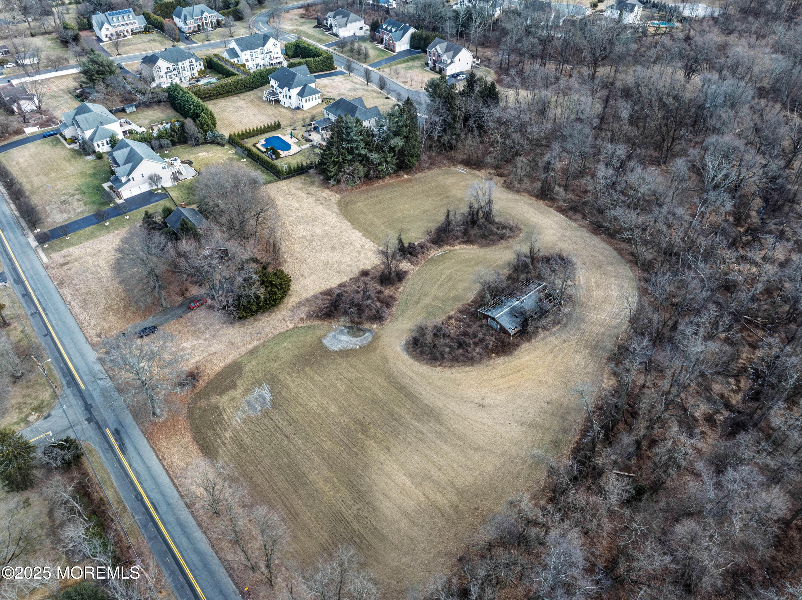 16 Pleasant Valley Road Morganville, NJ 07751 - Photo 11 of 18 a view of a dry yard with wooden fence